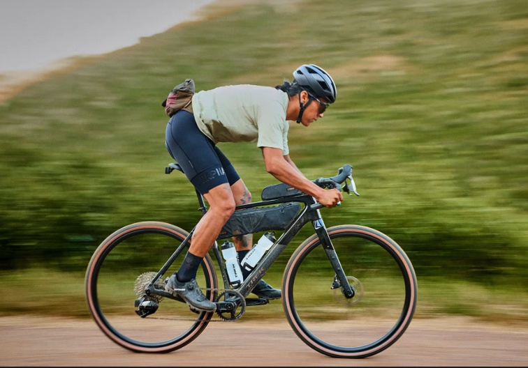 The original photo of a helmeted cyclist riding a road bicycle